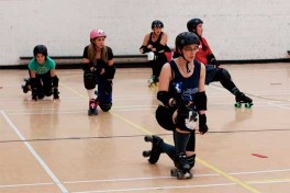 skaters stretch in their roller skates